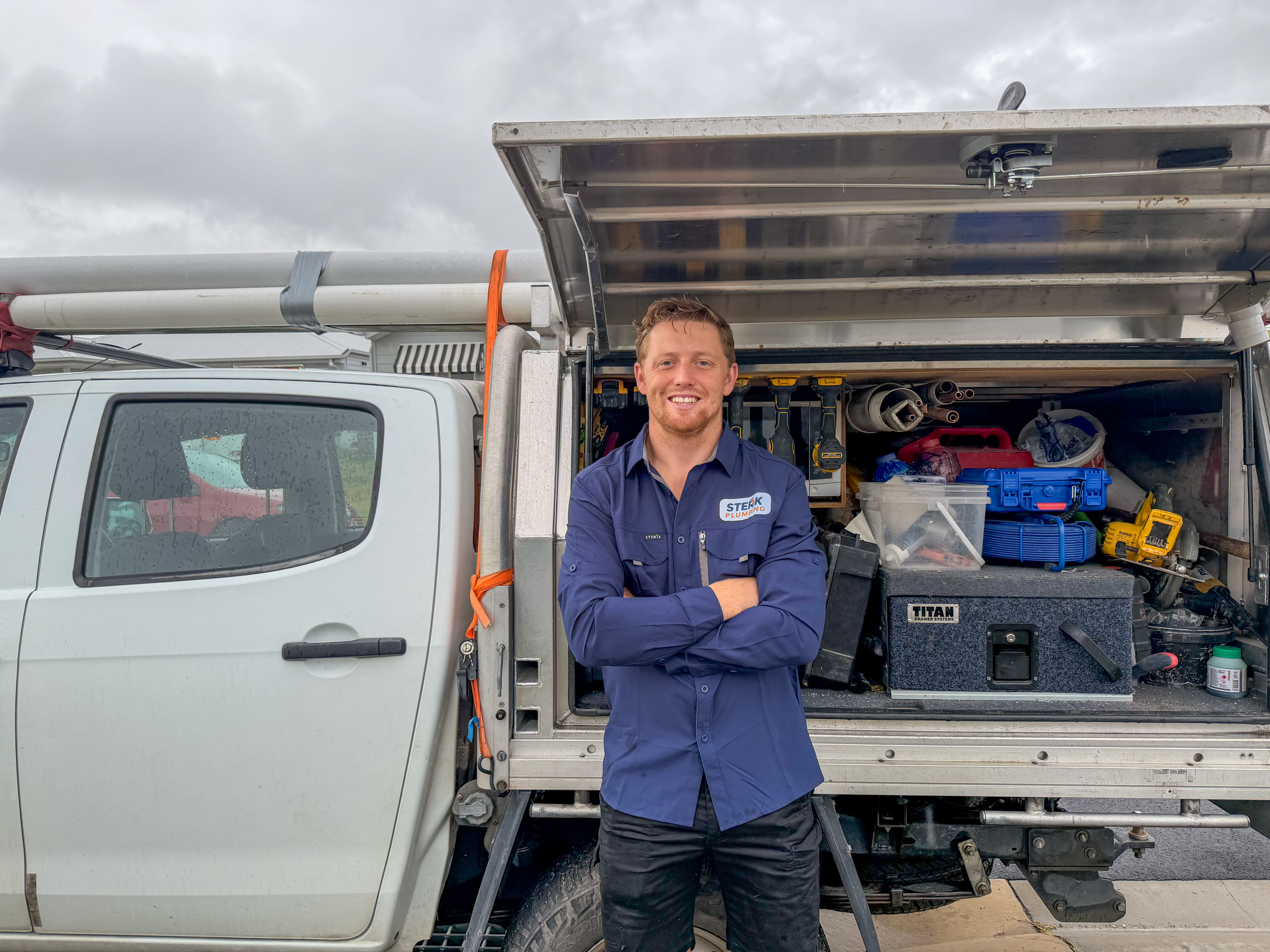 Frank from Sterk Plumbing standing in front of fully equipped service truck, Sunshine Coast
